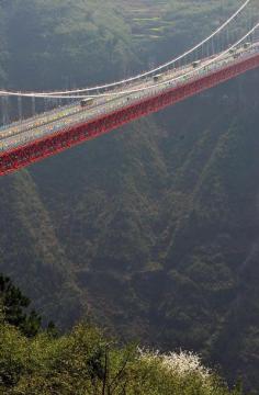 Aizhai suspension bridge in Xiangxi Tujia and Miao, China. Autonomous Prefecture, with a main span of 1,176 meters and a maximum height of 330 meters, was open to traffic on Saturday. Spanning over the Dehang canyon, the bridge was built as part of the expressway from southwest China's Chongqing Municipality to Changsha city in Hunan.