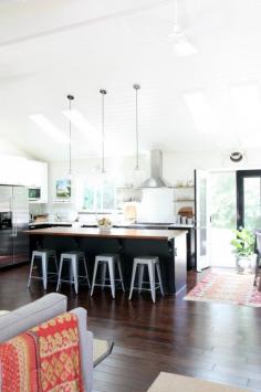 Dana Miller's Kitchen with walnut-topped island, Ikea  Ramsjö Black Kitchen Cabinets, Tolix Stools | Remodelista