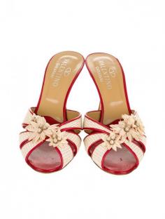 Red and natural woven crossover slides with flower embroidered accents at front and gold-tone metal tip heels.