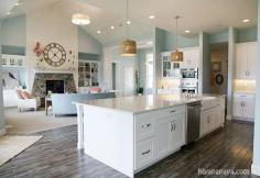 kitchen and family room... costal colors.. Especially love that huge island.. would love darker flooring though