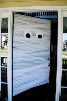 Mummy door made with white streamers and giant construction paper eyes.  So easy and so amazing looking!