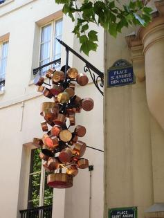 Grape-like configuration of copper pots - Place St. Andre des Arts in Paris, France