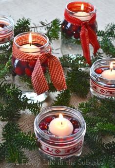 A simple & pretty Christmas table. Love the use of mason jar candles, evergreens and cranberries!