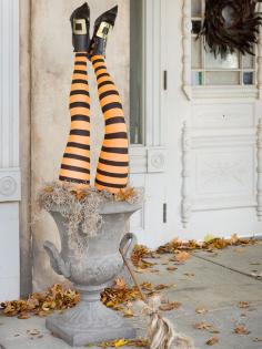 •Upside-Down Witch Halloween Urn    This easy-to-make Halloween decoration looks like a wayward witch landed headfirst in a moss-filled urn. To re-create the look, dress bendable mannequin legs (available online) in striped hose and buckled shoes. Place upside down in a tall urn filled with moss by your front door.