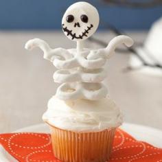 Halloween Skeleton cupcakes.  Head is a marshmallow and body is yogurt-covered pretzels.