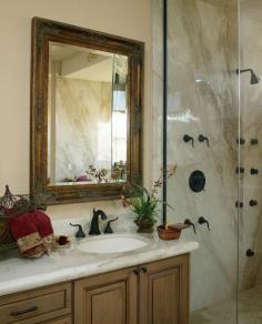 Traditional bathroom and shower with a granite slab shower surround, a wood stained vanity, black shower fixtures and a glass shower door. See what the door cost! #showers