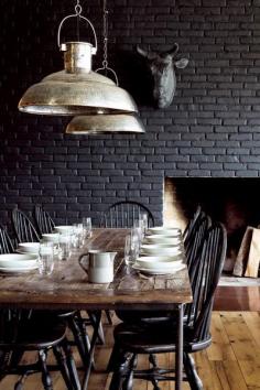 
                        
                            Dark dining space with farm-style wooden dining table.
                        
                    