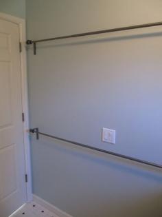 
                        
                            "Use stacked curtain rods in laundry room to hang dry clothes or to air dry wet clothes."
                        
                    