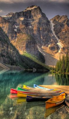 Colorful canoes on Moraine Lake at Banff National Park in the Canadian Rockies of Alberta, Canada