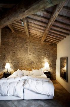 
                    
                        Rustic bedroom with stone wall//
                    
                