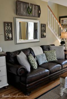 
                        
                            Our brown couch, grayish/sageish wall paint, those patterned drapes from target, cream leather recliner and a throw rug
                        
                    