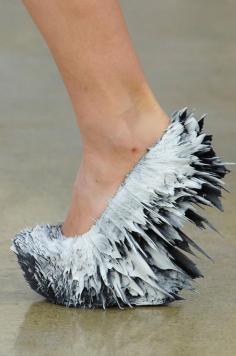 These are interesting shoes  light splattered shoes.  Iris Van Herpen