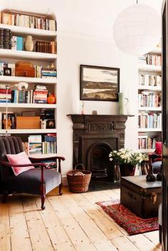 
                    
                        Bookshelves filled with books and wood fireplace
                    
                
