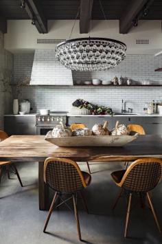 Cool light fixture for dining room.  Ochre Arctic Pear Chandelier over wood dining table in rustic kitchen, white subway tile, Jessica Helgerson Kitchen | Remodelista
