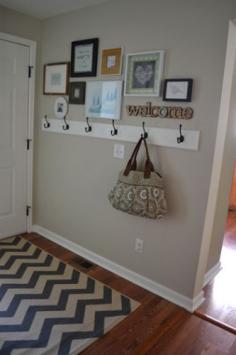 
                    
                        Storage solution for small entryway - add hooks. Frame gallery and chevron rug add visual interest.
                    
                