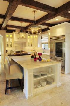 White kitchen, wood beams warm up the space. Awesome light fixtures