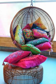 A few coloured cushions. Love the swing chair!