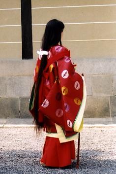 
                    
                        A woman dressed in traveling junihitoe for a historical parade.
                    
                
