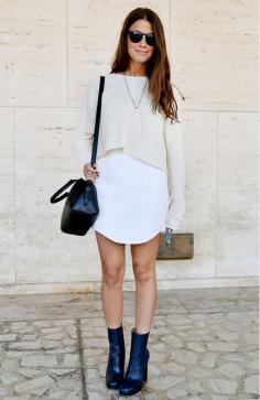 White crop top layered over white mini dress and black ankle boots