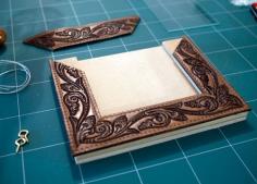 Make a frame out of a old leather belt to replace the girls Eiffel Tower picture frame