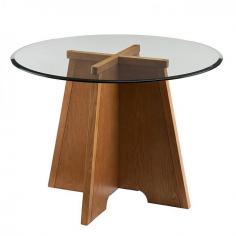 Anya Dining Table Update your breakfast or dinner area with this Art Deco inspired round table. Match your favorite chairs to this casual dining pedestal table to create a unique look that's contemporary and eclectic. Interlocking panels form an architectural design in a tapered frame, while wood grain details add tone and texture with a natural oak finish. The clear tempered glass top with a sleek bevel extends past the base for a floating edge that is refined and easy to clean.