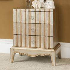 This petite chest has a huge personality. Finished in a luminescent Kennan Silver and Gold Wash, the elegantly scallop shape on the three drawer fronts adds architectural interest. A decorative skirt, tapered legs and simple ring pulls all contribute.