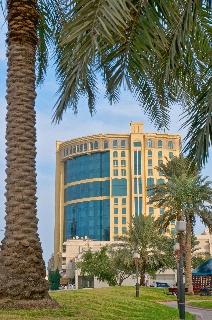 The business hotel is located on Ras Abu Aboud Street within the city's major access routes and on the main road to the new Doha International Airport. The hotel is 15 minutes' drive from the airport, a short walk from Corniche Road and a short drive to most of the city's shopping centres. This luxury hotel in the centre of Doha offers warm hospitality, an inviting atmosphere and top-notch services sure to please business and leisure travellers alike, perfect for organising any kind of corporate or social event. The air-conditioned business hotel offers 218 rooms in total and welcomes guests in a lobby with 24-hour reception and currency exchange facilities. Further facilities available to guests include a cafe, bar, restaurant, conference facilities, WLAN Internet access and room service. The hotel offers newly renovated, welcoming and relaxing bedrooms, furnished in a modern design, each featuring a double to king-size bed and a private bathroom with a shower or bathtub and a hairdryer. All rooms are equipped with air conditioning, wireless Internet access, a telephone, central heating, satellite TV, minibar, safe, tea and coffee making facilities and a desk. Non-smoking rooms are available on request. The hotel is equipped with a large outdoor swimming pool, an indoor hot tub, a fully equipped gym and a sauna and steam room. Guests can enjoy a cosmopolitan blend of Japanese, Asian, Indian, Arabic, European and Mediterranean cuisines prepared at the hotel restaurant. Breakfast is served each morning and set menu options are available for lunch and dinner.