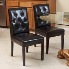 * Includes 2 dining chairs * Arrives fully assembled * Supple bonded leather * Sturdy wood frame * Espresso-stained wood legs * Diamond-patterned tufting * Softly padded seat bottom and back * Perfect in a dining room or can be useful in any part of the house for additional comfortable seating. Set of two (2) Color: Black Materials: Bonded leather Finish: Espresso-stained Legs One-piece construction with stable frame, has no assembly Tufted bonded leather backs for added style and comfort Seat height: 18 inches Dimensions: 35.75 inches high x 17.0 inches wide x 19.75 inches deep Number of boxes this will ship in: One (1) type: Leather Chairs material: Leather style: Casual assembly required: FALSE features: Armless