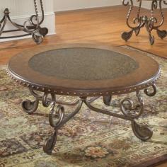 Beautiful round traditional style coffee table. Round wood and metal top metal legs. Medium wood finish. Interesting metal nailhead trim. Etched metal design. 41.75DIA x 20H inches. Art meets function in Bernards Metal Etched Round Coffee Table with Nailheads. This table is perfect for any living room or space that calls for a little extra architectural interest. The table top is etched metal surrounded by a medium wood trim. The round top is finished with a beautiful nailhead design around the sides. Curved metal legs support this functional piece of art for your living space. This coffee table is designed to match the Bernards Metal Etched Console Table and End Table. You may purchase it alone or with these additional items to complete the collection. About BernardsBernards is an importer and distributor of residential home furnishings. They offer products for all rooms at affordable prices and styles from traditional to contemporary. In order to bring the best values to their customers Bernards shops the world for specialties to meet the needs and desires of their retailers and customers. Located in Archdale NC. Bernards was founded in 1983 by Herman Bernard a pioneer in furniture importing. He set the standard for integrity that has been the foundation of the company ever since. You can count on Bernards to give you the facts and stand behind the products they sell.