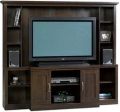 Decorative laminate entertainment center Deep cinnamon cherry finish Features 7 adjustable shelves and 2 cabinets Holds TVs weighing up to 95 pounds Measures 71.4L x 16.5D x 62.1H. The Sauder Entertainment Center is a beautiful way to organize your media as well as display some of your favorite decorative pieces. With seven adjustable shelves you have more than enough room for books speakers a DVR DVD player and any other items that will perfectly display your taste and style. The two cabinets help you to keep your home entertainment center looking neat and organized while keeping necessary items close at hand. This entertainment center can hold TVs weighing up to 95 pounds and features a gorgeous cinnamon cherry finish. Additional Features Assembly required Includes a 5-year limited warranty About SauderSauder is North America's leading producer of ready-to-assemble (RTA) furniture and the nation's fifth largest residential furniture manufacturer. Based in Archbold Ohio Sauder also sources furniture from a network of quality global partners including a line of office chairs that complement its residential and light commercial office furniture. Sauder markets more than 30 distinct furniture collections in a full line of RTA furnishings for the home entertainment home office bedroom kitchen and storage. Sauder is a privately held third-generation family-run business. The company prides itself on its awareness that all function and no fashion makes for a dull living space when it comes to home furnishing products. That's why Sauder's award-winning design team has produced more than 25 collections of stylish furniture that span the design spectrum. From minimalist modern or contemporary to classic 18th century or country styles Sauder has what you're looking for. The company offers more than 500 items - most priced below $500 - that have won national design awards and generated thousands of letters of gratitude from satisfied consumers.