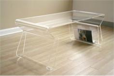Deena Acrylic Coffee Table with Magazine Rack - This coffee table has a beautiful minimalistic, low-profile look. The clear acrylic is thick, strong, and functional with curved legs that function as magazine racks. Add something colorful to the racks to make it stand out. Matching clear acrylic end tables are available to complete your set. Dimensions: 17"L x 39"W x 15.5"H Order yours from Brookstone today!