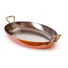 Roasted vegetables or beef fillets can be beautifully presented in this elegant 17.5-in. Oval Pan. This handled casserole-type pan is crafted from copper and has a stainless steel interior that won't interact with foods and makes for easy cleaning. Copper is a terrific choice for cookware because it is twice more conductive than aluminum and ten times more conductive than stainless steel. No wonder copper is the most preferred material of cookware by popular chefs and avid home cooks; its ability to heat up evenly and rapidly and to cool down just as quick allows for maximum control and excellent cooking results. Please handwash with mild dish soap. Made in France. The Cuprinox Pour la Table line is designed for both attractive serving and efficient cooking. The copper construction is especially ideal for high-heat recipes such as sautes or stir-fries. Bronze handles are fixed by sturdy stainless steel rivets and they are easy to clean with no retinning required. Pots, pans and items from the Cuprinox Pour La Table line can be used for any heating element except on an induction hob. Mauviel, a French family business established in 1830 and located in the Normandy town of Villedieu-les-Poeles, is the foremost manufacturer of professional copper cookware in the world today. Highly regarded in the professional world, with over 170 years of experience, Mauviel offers several different lines of copper cookware to professional chefs and home cooks that appreciate the benefits of their high quality products.