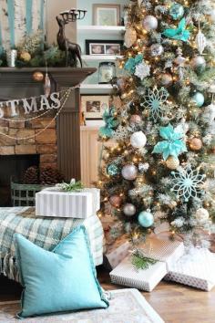 Icy blue Christmas decor with touches of silver, gray, and gold make this Christmas tree a dazzling one. 
Get the tutorial at Refresh Restyl...
