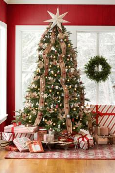 Adorned with jingle bells, red jute webbing runs down the length of the tree. Burlap poinsettias add a decorative touch, and a seven-point s...