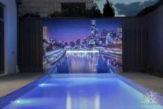 A Poolside Wall Art feature was custom made with a fountain residing in the centre. The diverse piece on display for the outdoor entertainment area is strategically positioned. While generating perspective at the base of the mural, carrying the tiles into the foreground. Gives the artwork depth. A cityscape selected by the client blends fantastically with the modern pool decor. Due to the shape of the blueboard wall, the image was framed. Fitting the fountain directly under the centre bridge in the picture. Ultimately balancing the graffiti photorealistic style. Resulting in one of our more professional exterior works.