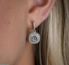 The Clara Drop Earrings are a statement making, yet subtle addition to any jewelry collection. Our Clara Halo dangles are sure to turn heads with their large 4 prong set center stones that are surrounded by sparkly, starlike pavé simulated diamonds.