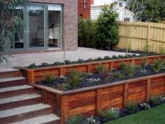 retaining wall idea for the back yard, I like the terraced appearance. Would be great on the side of a deck.