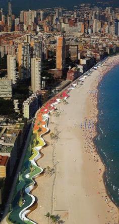 Colorful mosaic tile benches at the beach in Benidorm, Spain.