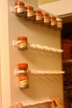 Forget the spice rack!!  Use a mop holder to store spices on the inside of a cabinet door. (no more searching through the deep cupboard for that one spice!)