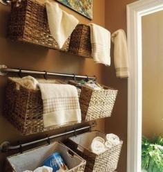 Hang Baskets on Rails to Store Towels and Shower Supplies | 52 Totally Feasible Ways To Organize Your Entire Home