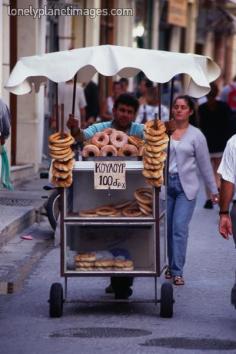 Street vendor pushing his stand and selling donuts, breads and pastries - Rethymno, Rethymno Province, Crete