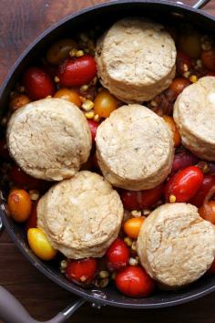 A savory tomato cobbler topped with cheddar buttermilk biscuits and filled with chipotle-roasted cherry tomatoes, fresh sweet corn, and delectable caramelized onions – it is sure to be the hit of whatever party you bring it to!
