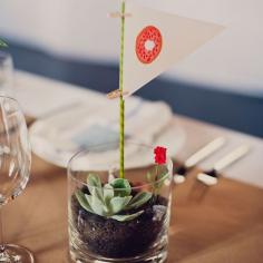This mini terrarium and pennant flag idea are so fun!! Love the idea of using illustrations instead of table names or numbers.