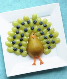 Fruit Turkey Snack--- except make a peacock instead of turkey by adding purple grapes and maybe do a dark pear body...