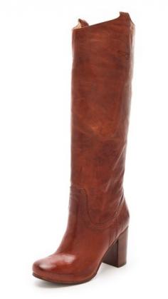 #FRYE. Glazed, variegated leather lends a well-worn vintage patina to these tall Frye boots, fashioned with a rounded toe and double pull-tabs at the top line. Stacked heel and leather sole.
