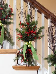 Natural birch branches form the backbone, but red twig dogwood or other branches would work just as well. Use thin florist's wire to lash them to the banister posts along with evergreens and sprays of bright red winterberries.