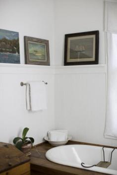 Wainscoting and nautical art bathroom