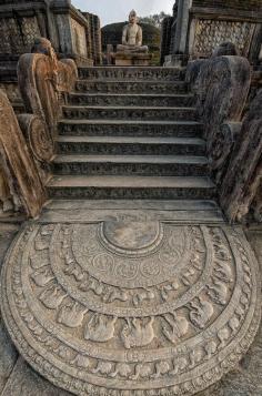 Ancient temple ruins in Anuradhapura in Sri Lanka. The intricately carved bottom stone is called the ‘Moonstone’ and the steps lead to a still intact, sitting Buddha