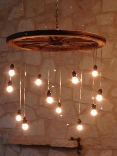 Idea for lighting to build: wagon wheel, pendant globe lights, chain. Random Length Wagon Wheel Chandelier large by RusticChandeliers, $400.00