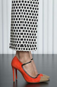 Stunning orange shoes with fawn toe-cap, and black-and-white geometric cuffed pants.  Etro